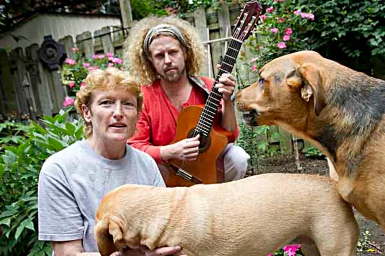 Shawn Hennessey, with mom Maureen Hennessy and their dogs Harper ( small ) and Scout in their back yard on the 400 block of W. Price St. in Germantown section of Philadelphia on Thursday, July 11, 2013. He has created a campaign for public contributions to help his mother and bring an awareness to marriage equality in Pennsylvania. ( ALEJANDRO A. ALVAREZ / STAFF PHOTOGRAPHER )