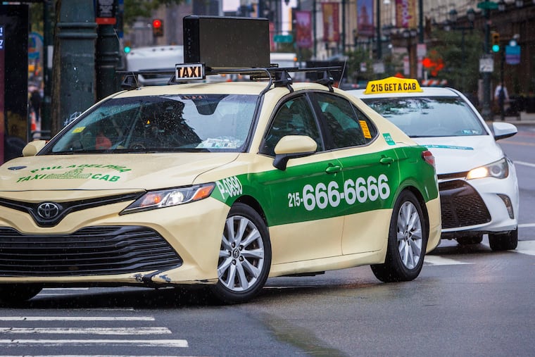 Taxis turning at 6th and Market Streets in 2024.