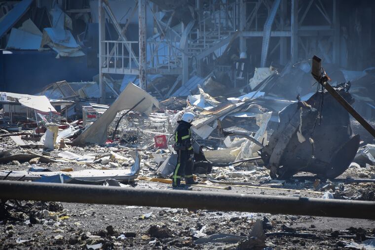 An Ukrainian firefighter works near a destroyed building on the outskirts of Odesa, Ukraine, on Tuesday.