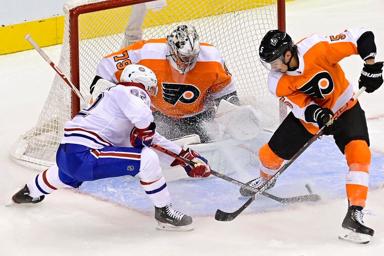 Flyers goaltender Carter Hart (79) makes a save on Montreal Canadiens' Artturi Lehkonen (62) as Flyers' Philippe Myers (5) defends during the second period.