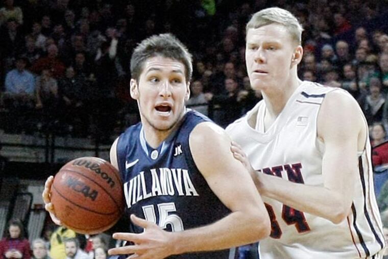 Villanova's Ryan Arcidiacono charges around Penn's Sam Jones. (Elizabeth Robertson/Staff Photographer)