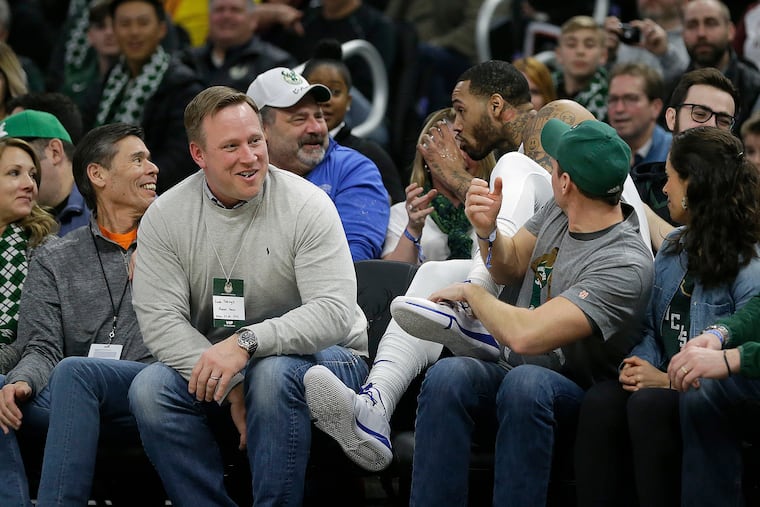 Mike Scott sips a fan's drink in the stands.