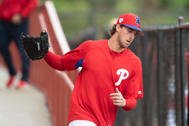 Phillies pitcher, Aaron Nola, runs to the field during the first day of spring training at Spectrum Field in Clearwater, Fla. on Wednesday.