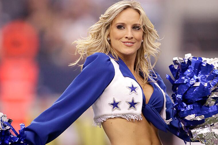 A member of the Dallas Cowboys cheerleaders performs during a game against the St. Louis Rams, Sunday, Sept. 22, 2013, in Arlington, Texas. (Tony Gutierrez/AP)
