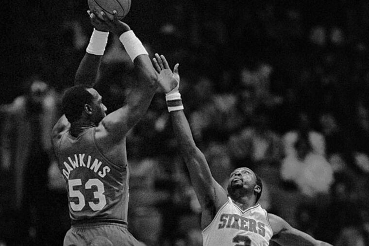 In this April 20, 1984, file photo, New Jersey Nets' Darryl Dawkins (53) towers over Philadelphia 76ers' Moses Malone (2) as he gets off.