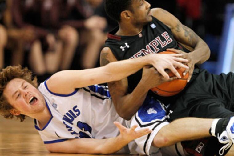 Saint Louis' Kyle Cassity and Temple's Ramone Moore fight over a loose ball. (Jeff Roberson/AP)