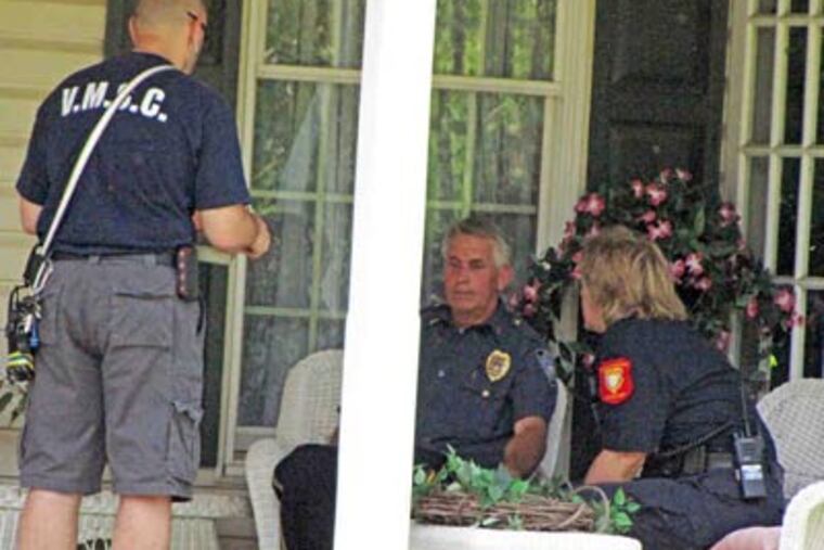 Eric Schmitz , a Hatfield Township police lieutenant, sits on the porch of his Towamencin home after the shooting. (Andy Stetler / The Record)