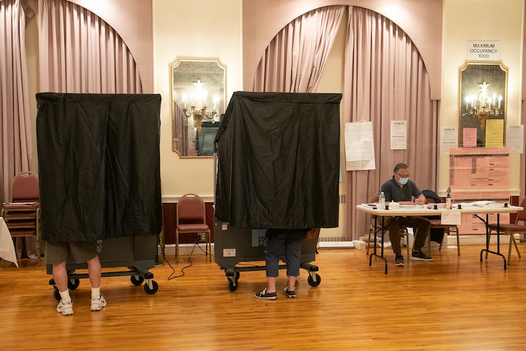 People vote inside of the polling place at St. Thomas Indian Orthodox Church in Northeast Philadelphia last week.
