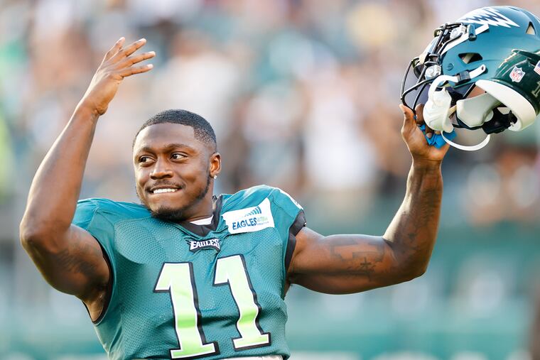 Eagles wide receiver A.J. Brown raises his arms before the start of a public practice at Lincoln Financial Field on Sunday, August 7, 2022.