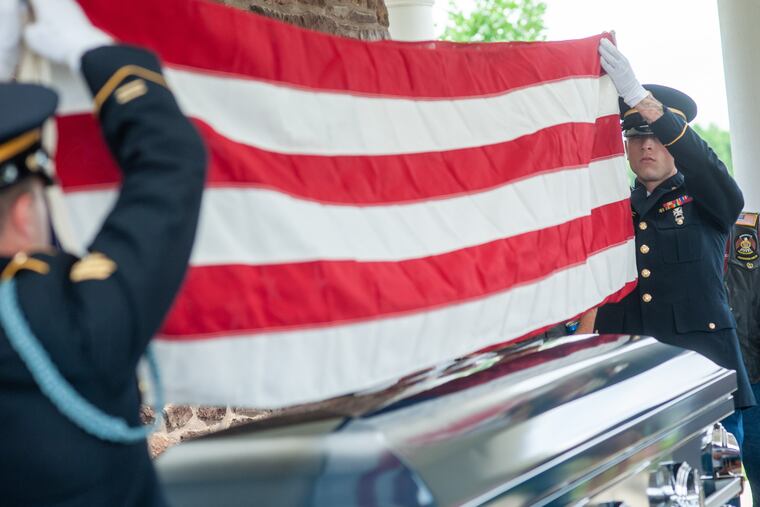 Sgt. Thomas Morris (left) of the Pennsylvania Military Funeral Honors Program and William Leuters (right) of 1067th Transportation Company fold the American flag that draped over the casket during funeral services for Army Sgt. Matthew Francis Kelly, 70, of Philadelphia Wednesday, July 10, 2019 at Washington Crossing National Cemetery in Upper Makefield, Pennsylvania. Kelly's wish was to be buried with full military honors and a welcome home parade, which upon his return from Vietnam he never received. WILLIAM THOMAS CAIN / For The Inquirer
