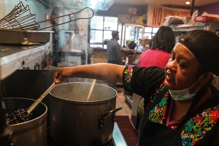 Natalia Méndez cooks in the kitchen of La Morada, an award winning Mexican restaurant she co-owns with her family in South Bronx, Wednesday Oct. 28, 2020, in New York. After recovering from COVID-19 symptoms, the family raised funds to reopen the restaurant, which they also turned into a soup kitchen serving 650 meals daily. (AP Photo/Bebeto Matthews)