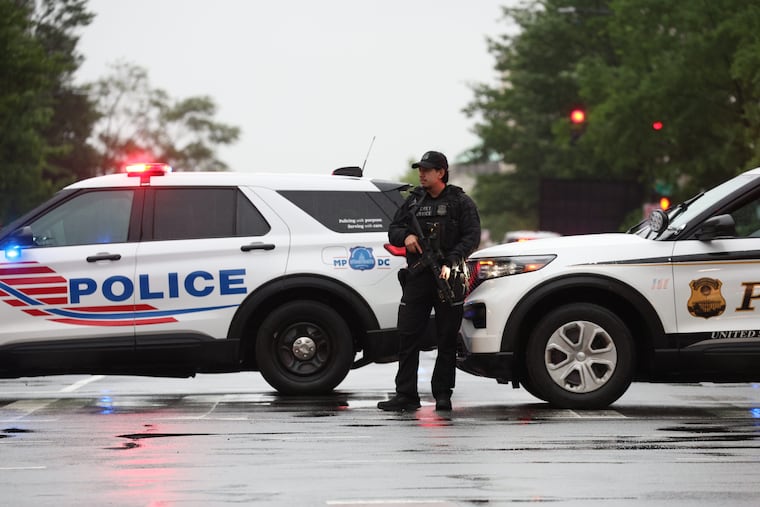 A member of law enforcement stands guard Saturday after an exchange of gunfire near the White House.