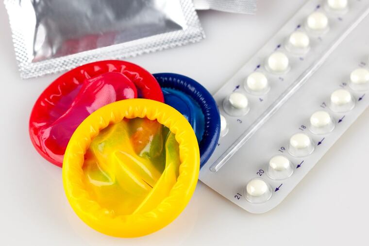 birth control pills and condoms, isolated on white background