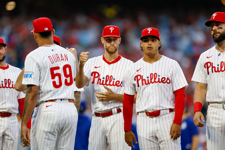 Phillies pitcher Zack Wheeler fist bumps Jhoan Duran before the start of Game 1 of the NLDS on Saturday.