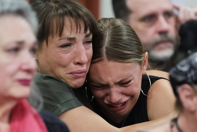 Dylan Mortensen gets a hug after speaking at the sentencing hearing of Bryan Kohberger at the Ada County Courthouse, for his sentencing hearing on Wednesday in Boise, Idaho, for brutally stabbing four University of Idaho students to death nearly three years ago.