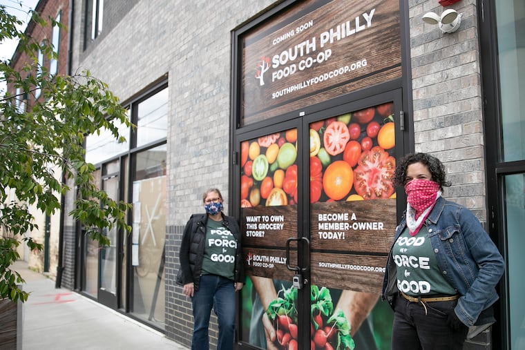 Leigh Goldenberg, South Philly Food Co-op board president (right) and Lori Burge, general manager, pose for a portrait outside of the South Philly Food Co-op in South Philadelphia on Tuesday, May 12, 2020. The South Philly Food Co-op has been in the works for 10 years. They were about six weeks from completing work on their grocery store in March when the pandemic shut down construction. Work is getting underway again, and they hope to open the store by the end of the year.