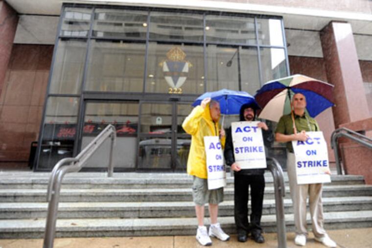 Archbishop Ryan teachers Kevin Pall, Carl Tori and Michael Costanzo protest outside Archdiocese of Philadelphia offices on Tuesday.