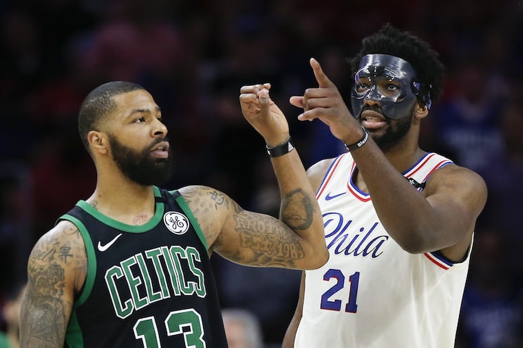 Sixers center Joel Embiid points his finger towards the score board while Boston Celtics forward Marcus Morris indicates a zero with his finger late in the fourth quarter during Game 4 of the Eastern Conference semifinals on Monday.