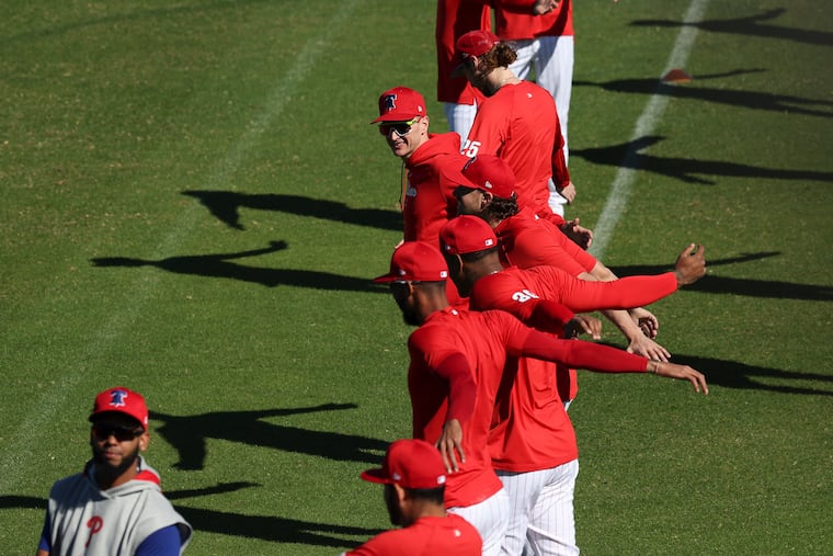 Phillies pitchers warm up and stretch at BayCare Ballpark on Wednesday for the first day of spring training in Clearwater, Fla.