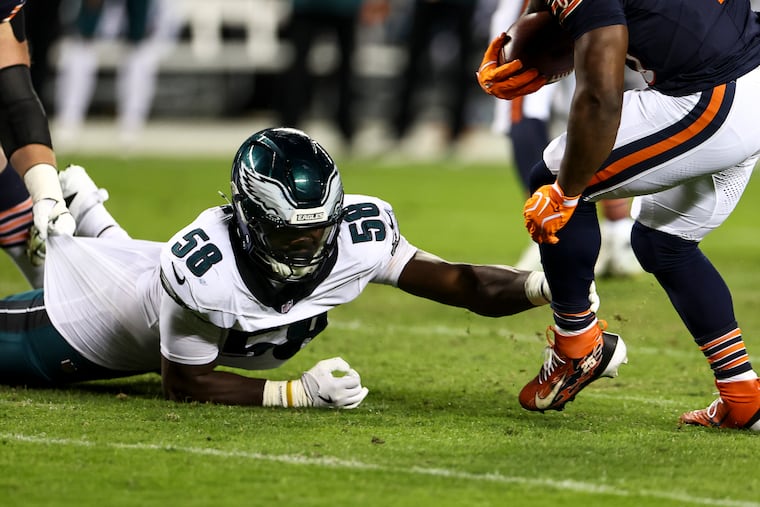 Philadelphia Eagles linebacker Jalyx Hunt grabs Chicago Bears running back Kyle Monangai during the Chicago Bears game against the Philadelphia Eagles at Soldier Field on Monday, Sept. 28, 2026 in Chicago.