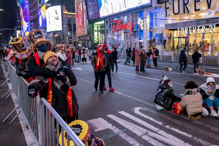 Revelers, in small groups in some areas, gather in Times Square for New Year's Eve celebrations.