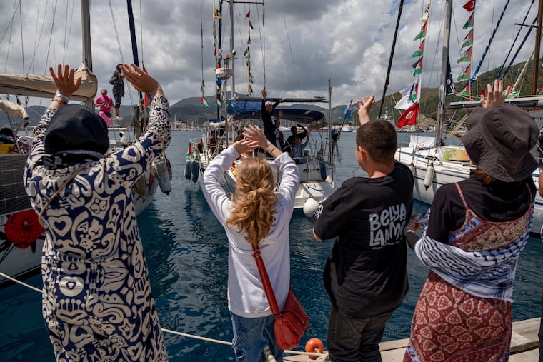 People wave to boats belonging to the Global Sumud Flotilla, carrying activists and humanitarian aid, depart for Gaza from the port of Marmaris, Turkey, Thursday, May 14, 2026, in an attempt to break the Israeli naval blockade.