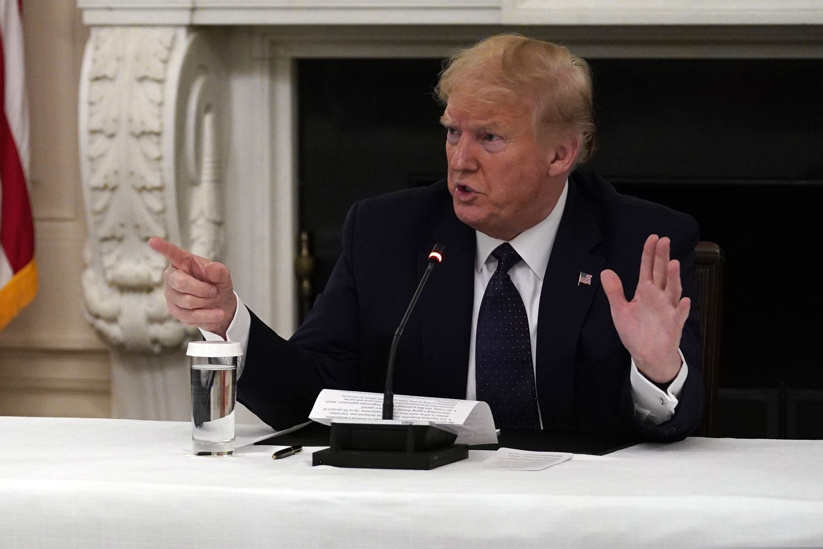 President Donald Trump tells reporters that he is taking zinc and hydroxychloroquine during a meeting with restaurant industry executives about the coronavirus response, in the State Dining Room of the White House.