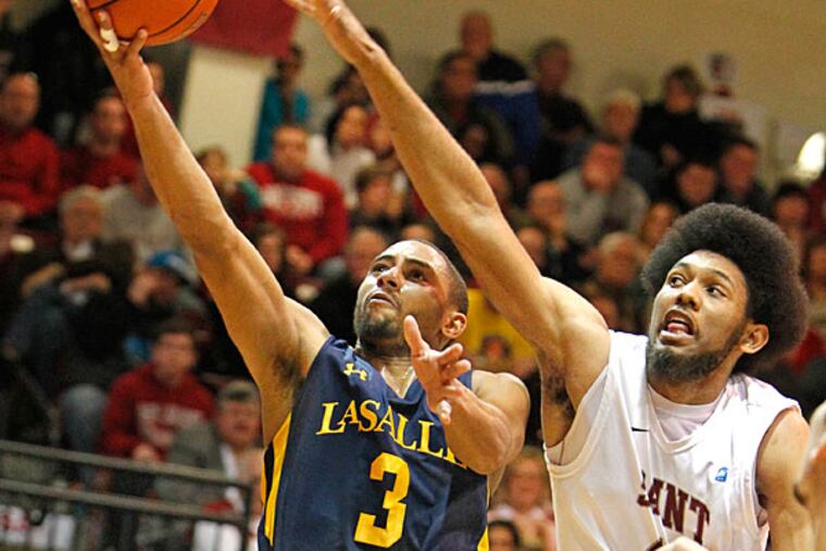 La Salle's Tyreek Duren scores the basket and gets fouled by St. Joe's
DeAndre' Bembry. (Ron Cortes/Staff Photographer)