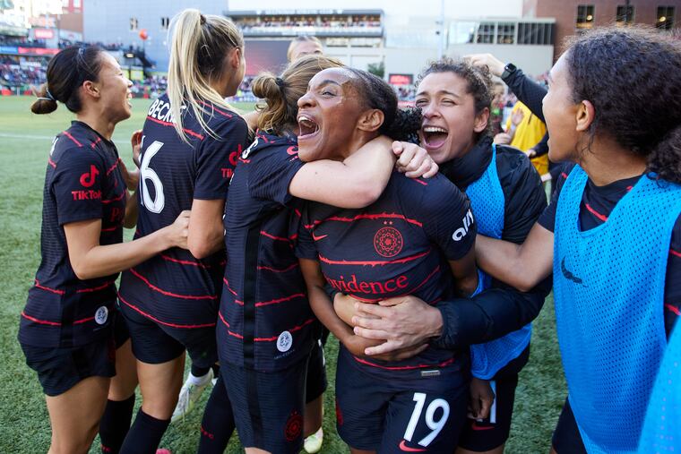 Crystal Dunn (19) celebrates with teammates after her game-winning goal for the Portland Thorns in the NWSL playoffs semifinals.