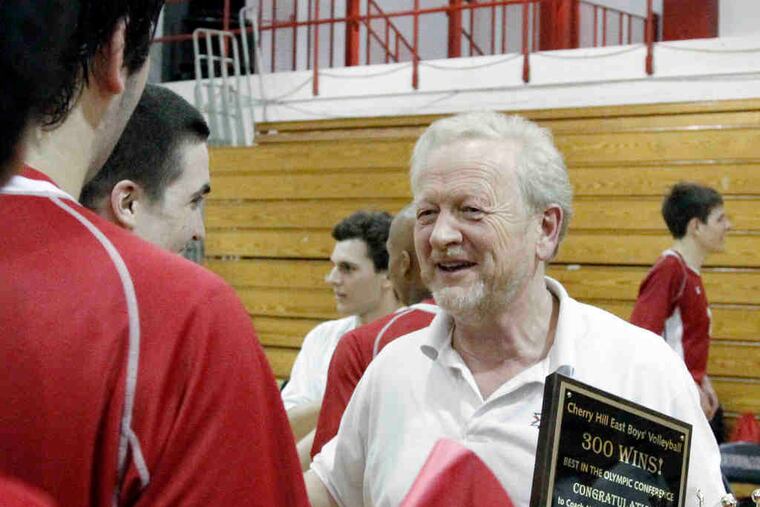 Cherry Hill East volleyball coach Karl Moehlmann is congratulated by his players after they beat Clearview to hand him his 300th victory. "Everybody can get to 300 if you stay long enough," Moehlmann said modestly.
