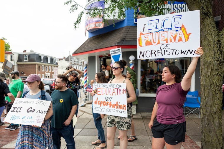 Lydia Villalba, 27, of Souderton, Pa., (right), holds a sign saying “Ice Fuera De Norristown” meaning Ice out of Norristown, during a rally to support immigrants in Norristown, Pa., on Saturday, June 7, 2025.