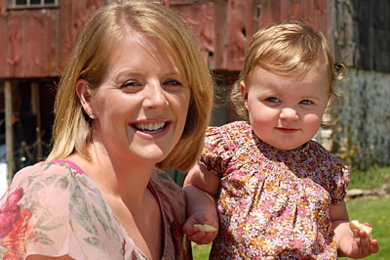 Grumpymoms.com creator Shannon Lelli poses with 1-year-old
daughter Taylor Lelli in tje back yard of her Applebachsville home. (Tom Gralish / Staff Photographer)