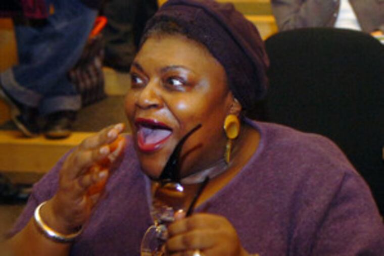 Sacaree Rhodes reacts as she wins a citizenship award at a King Day event. Story, B4.