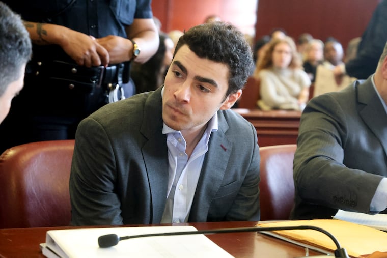 Luigi Mangione, charged in the murder of UnitedHealthcare chief executive Brian Thompson, confers with one of his attorneys at a pretrial hearing.
