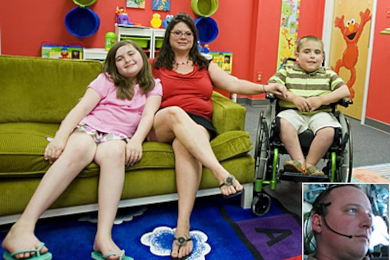 Chrissi Keefer and her children, Sara and Jaxon, relax in the brightly appointed family lounge at McGuire Air Force Base. The room was dedicated six months ago in honor of Keefer's husband, Jason, (inset).