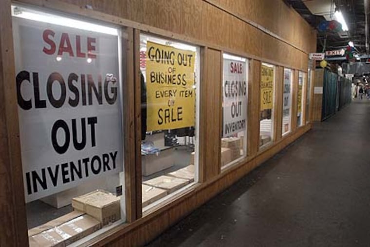 File photo showing going out of business signs at a store.