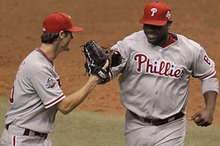 Cole Hamels, left, and Ryan Howard walk off the field in the seventh inning of the Phillies' 3-2 win over the Rays in Game 1 of the World Series. (David Maialetti / Staff Photographer)