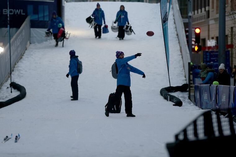 A volunteer tosses a football at the NFL Live event in downtown Minneapolis on January 28, 2018.