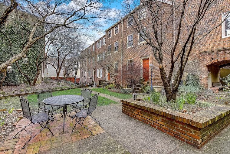 The quiet common area behind the rowhouses can make you feel like you're far from the busy city, the home owner says.