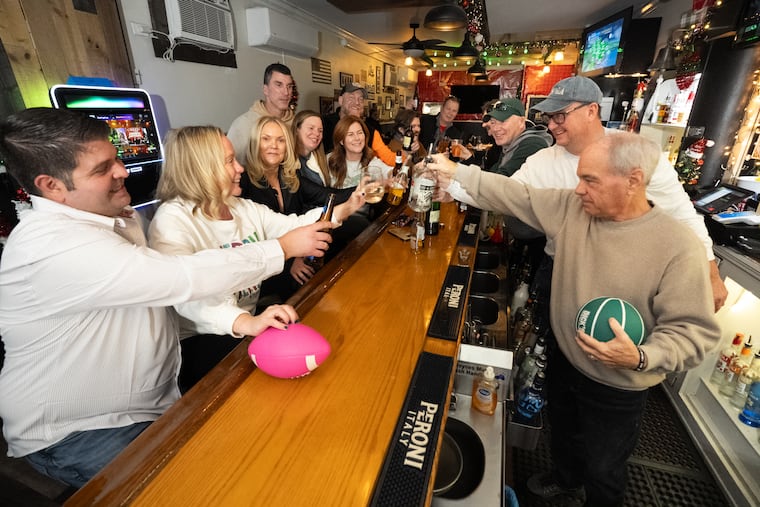 Raising a toast at Wolf Burger, from left, are John Thomas, Jen Barkowitz, Amy Reilly, Russell Wilson, Leigh-Ann Wilson, Ashleigh Renzi, Chris Wray, Joe Ferretti, Bob Cooney, Ed Barkowitz, and Mike Kern.