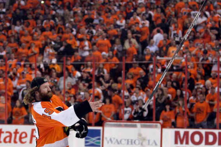 Scott Hartnell tosses his stick into the crowd as the Flyers celebrate their berth in the Stanley Cup finals.