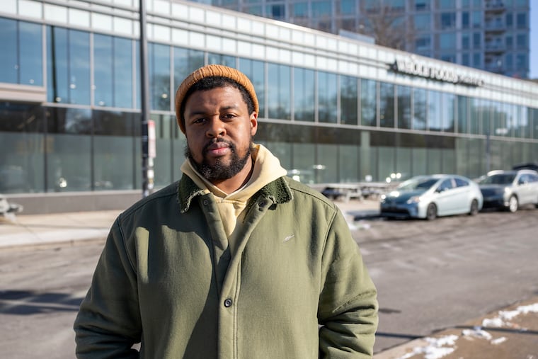Edward Dupree, 34, of West Philadelphia, who works on the produce team at Whole Foods, is pictured Dec. 16 outside his store.