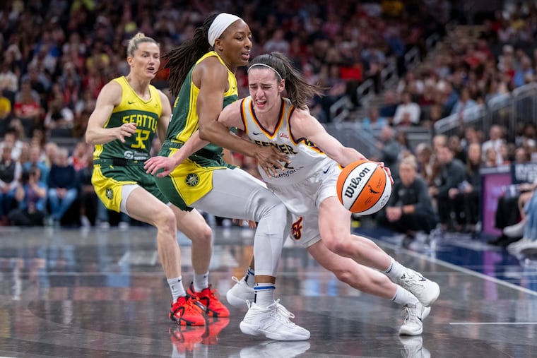 Indiana Fever guard Caitlin Clark (right), driving against Seattle Storm forward Nneka Ogwumike, has sparked debate around the WNBA.