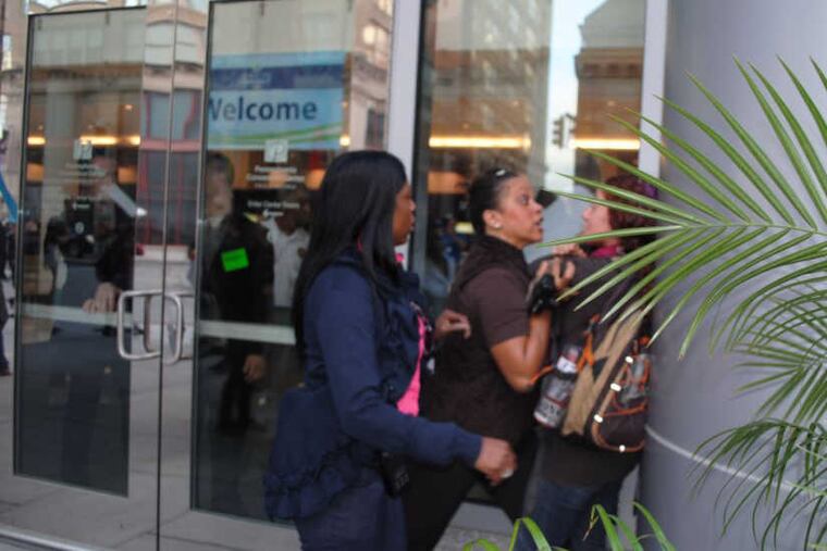 Amanda Geraci is pressed against a wall by a Philadelphia Police officer after she tried to video-record cops responding to a protest.