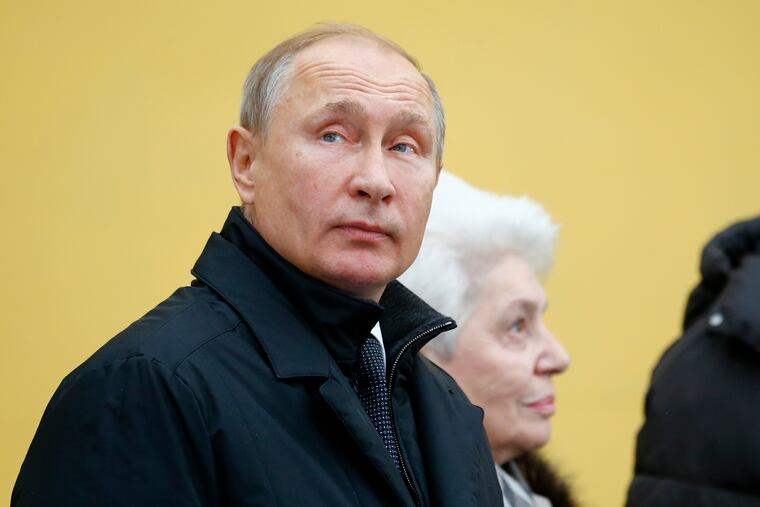 Russian President Vladimir Putin looks at a monument to the Nobel Prize-winning author Alexander Solzhenitsyn in Moscow, Russia, Tuesday, Dec. 11, 2018. Solzhenitsyn, whose books exposed the horrors of Soviet prison camps, died in 2008. (AP Photo/Alexander Zemlianichenko, Pool)