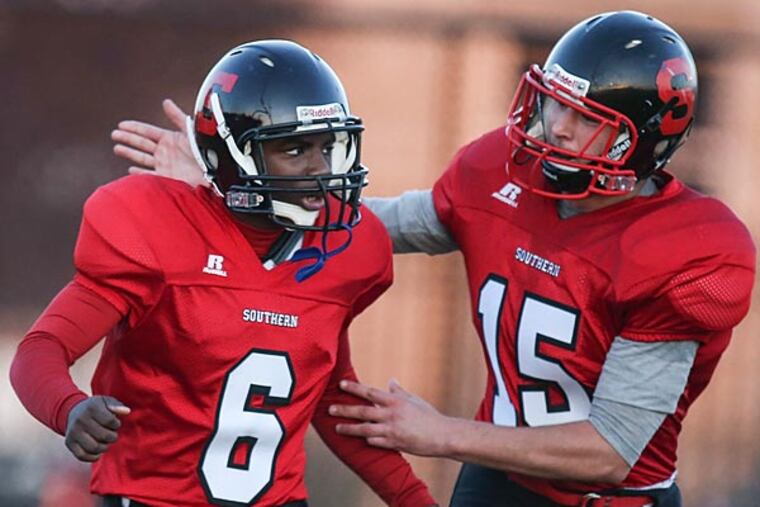 Southern's Qashah Carter (6) celebrates with teammate Walter Tweed
after his interceiption that he ran for a touchdown. (Steven M. Falk/Staff Photographer)