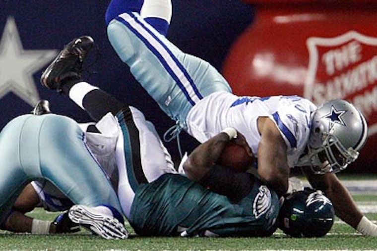 The Cowboys' defense hit Michael Vick hard throughout the game. (Ron Cortes/Staff Photographer)