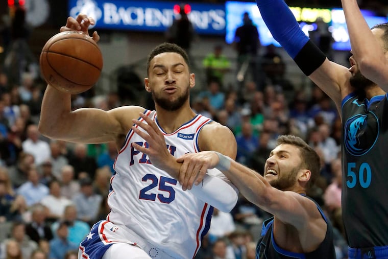 Sixers guard Ben Simmons (25) drives to the basket against Mavericks defenders Maximilian Kleber (42) and Salah Mejri during the first half.