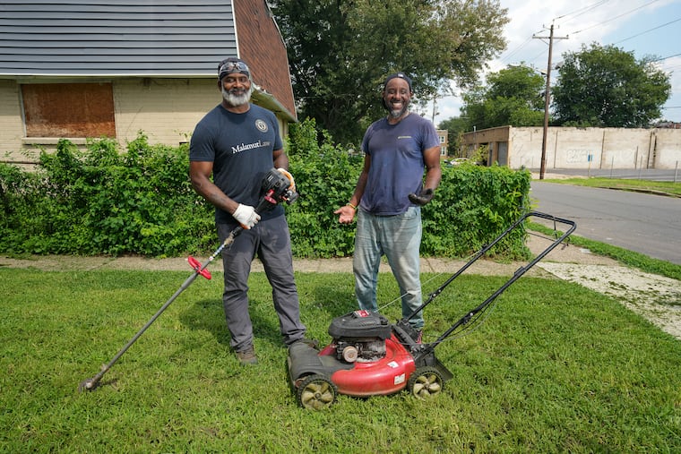 Keith Benson and his childhood friend Brian Turner help residents and the community by providing free lawn care, in Camden, N.J., July 31, 2026.