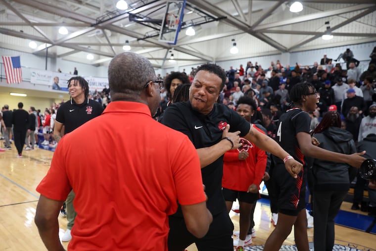 Imhotep coaches cheer after winning the PIAA 5A state semifinals at Bensalem High School on March 18.